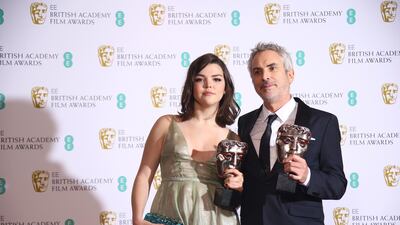 Director Alfonso Cuaron poses with his daughter, Tess Bu Cuaron, with his Best Film and Best Director awards. AP