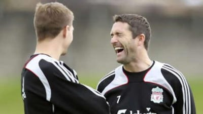 Robbie Keane, right, enjoys a joke with Steven Gerrard in Liverpool training.