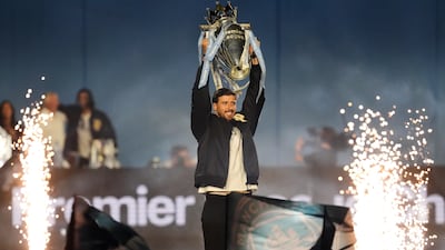 Manchester City's Ruben Dias with the Premier League trophy. PA