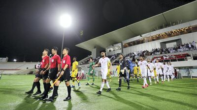 The teams come onto the pitch. Chris Whiteoak / The National