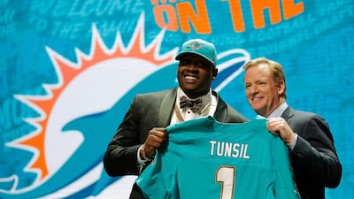 Laremy Tunsil holds up a Miami Dolphins jersey after being drafted by the team on April 28, 2016 in Chicago, Illinois. Jon Durr / Getty Images