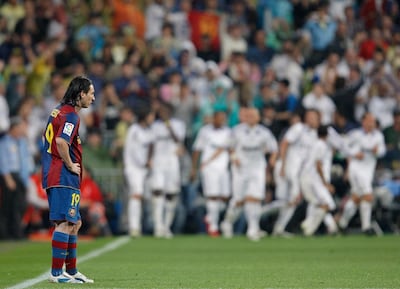 Lionel Messi of Barcelona stands dejected backdropped by celebrating Real Madrid players at the Santiago Bernabeu Stadium on May 7, 2008. Getty Images