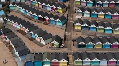 A man sunbathes in front of a row of beach huts in Walton-on-the-Naze amid temperatures of 30°C in parts of Britain. Getty Images