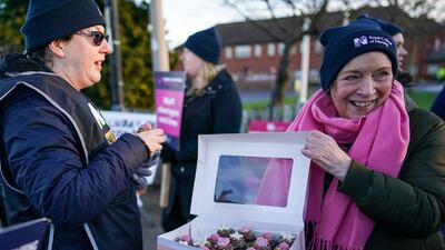 Cakes are offered as nurses from the Royal College of Nursing strike outside a hospital in Middlesbrough, England, on Wednesday. Getty.