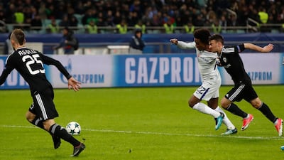 Willian, centre, has his shirt pulled by Gara Garayev for a foul and a second penalty. Pavel Golovkin / AP Photo