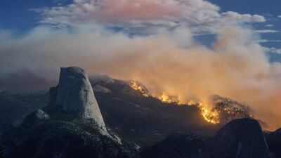 A wildfire burns next to Half Dome in Yosemite National Park, Calif. Michael Frye / AP