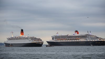 The Queen Elizabeth 2, left, is escorted by the Queen Mary 2 as they sail out of New York Harbour on October 16, 2008. AFP