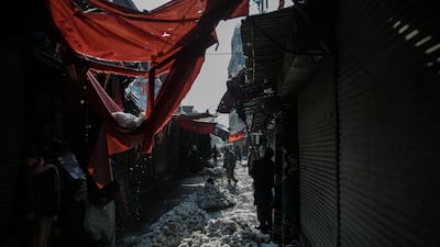 Traders clear snow from a street in Kabul, Afghanistan. EPA