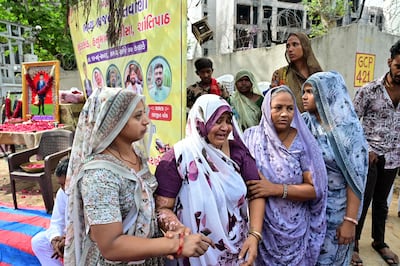 The mother of Air India Flight 171 plane crash victim Akash Patni grieves at the crash site on the first anniversary of the disaster. AFP.