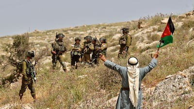 A Palestinian man confronts Israeli security forces during a protest against a new settler outpost in Beit Dajan in the occupied West Bank on April 29. AFP