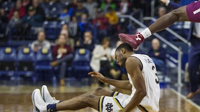 Notre Dame’s VJ Beachem is kicked in the head while competing for a loose ball with Colgate’s Jordan Swopshire during the second half of an NCAA college basketball game in South Bend, Indiana. Robert Franklin / AP Photo