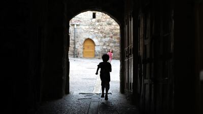 A child walks on an empty street in the old city of the West bank town of Hebron. EPA