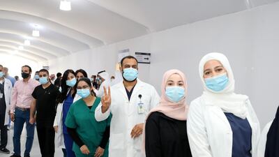 Medical staff at Dubai Parks and Resorts field hospital see off the final 17 coronavirus patients before the facility closes. Chris Whiteoak / The National