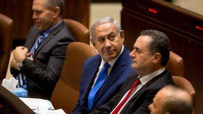 Israeli Prime Minister Benjamin Netanyahu, sits with Israeli Minister of Transportation Yisrael Katz, during an opening session at the Knesset, Israel's parliament in Jerusalem. AP / Sebastian Scheiner