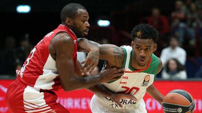 Laboral Kutxa Vitoria’s Darius Adams, right, dribbles past Olimpia Milano’s Oliver Lafayette during their Euroleague game on Friday. Matteo Bazzi / EPA