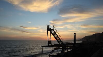 The sun sets beyond beachfront properties destroyed in the Palisades fire along the Pacific Ocean in Malibu, California. AFP