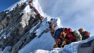 A long queue of mountain climbers line a path waiting to reach the summit Mount Everest during the deadliest climbing season in four years. AP