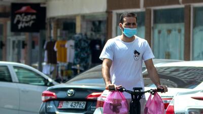An e-scooter user rides against the direction of traffic on Hamdan Steet, central Abu Dhabi. Victor Besa / The National