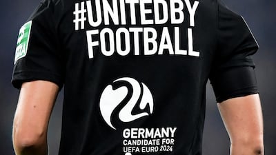 A referee's jersey reads 'United by Football' in support of Germany's candidacy for Euro 2024. Uefa will decide who out of Germany and Turkey wins the vote Thursday. EPA