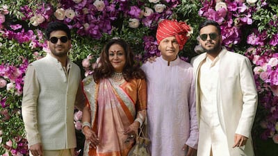 Indian businessman Anil Ambani (2nd R) poses for photographs along with his wife and former Bollywood actress Tina Ambani (2nd L) and their sons, Anshul Ambani (R) and Anmol Ambani (L). Photo: AFP