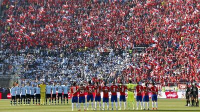The Argentina and Chile teams line up during national anthems prior to the 2015 Copa America final on Saturday at the Estadio Nacional in Santiago. Felipe Trueba / EPA