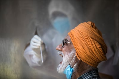 A health official collects a swab sample to test for Covid-19 in India's capital New Delhi. AFP