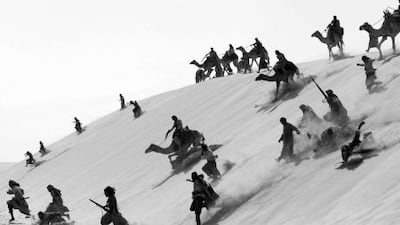 Warriors charge down a sand dune in a battle scene from Black Gold, filmed in Qatar and Tunisia.