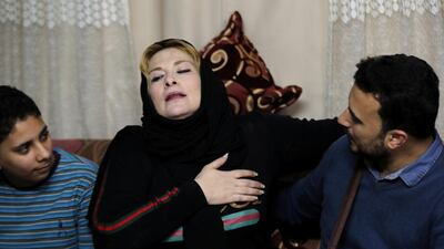 Nevine reacts during an emotional reunion with her son. Reuters