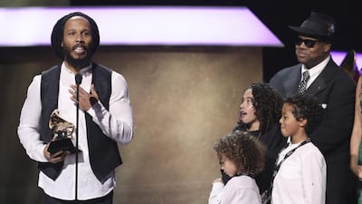 Ziggy Marley, left, accepts the award for best reggae album for Ziggy Marley at the Grammy Awards. Abraham Selassie Robert Nesta Marley, Gideon Robert Nesta Marley, Judah Victoria Marley, and Jimmy Jam look on from right. Matt Sayles / Invision / AP