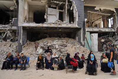 Patients sit among ruins in Al Shifa Hospital compound in Gaza city, after the dialysis unit suspended services due to a lack or fuel for its generators. AP Photo