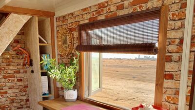 Looking out to the desert around Yas Island from inside the tiny house
