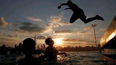 A boy jumps into a swimming pool at Asda City in Khan Yunis in the southern Gaza Strip. Mohammed Abed / AFP