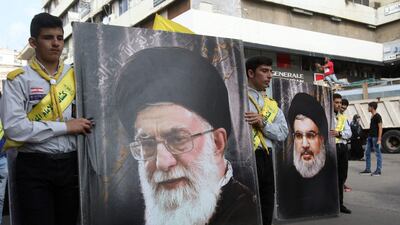 Hizbollah supporters carry posters of the head of the Lebanese Shiite movement Hezbollah, Hasan Nasrallah, right, and Iran's supreme leader, Ayatollah Ali Khamenei, during the funeral of three Hizbollah fighters killed in combat in Syria. AFP