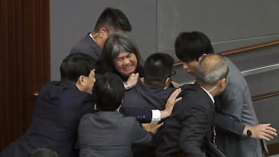 Newly elected pro-democracy lawmaker Leung Kwok-hung, top centre, tries to break through the security guards during the election of president of the Legislative Council in Hong Kong on October 12, 2016. A swearing-in ceremony descended into chaos as newly elected pro-democracy lawmakers intentionally mangled their oaths in a show of defiance against Beijing. Kin Cheung/AP Photo