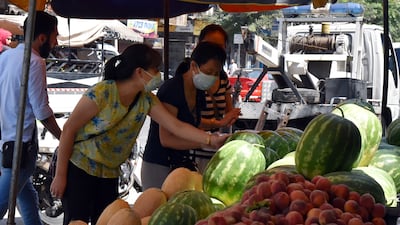 Syrians shop for vegetables at a market in Damascus on Sunday July 11, hours after Syrian President Bashar Al Assad issued a legislative decree granting civil servants and military members a 50 per cent pay rise. The decision comes a day after the government raised the price of fuel by more than 50 per cent for the third time this year. EPA