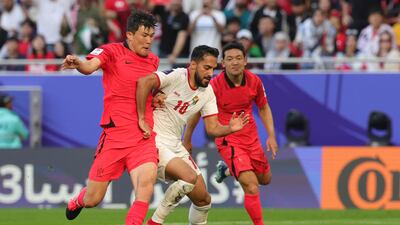 South Korea's Lee Ki-je vies for the ball with Jordan's Musa Al Tamari in Doha on Saturday. AFP