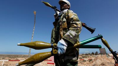 A Libyan rebel stands on a vehicle holding several RPGs at an advance check point between the oil town of Ras Lanouf and Bin Jawad town, eastern Libya yesterday.