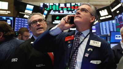 Traders Eric Schumacher, left, and Richard Deviccaro on the floor of the New York Stock Exchange. US equity markets were down 6.9 per cent in October. Photo: AP