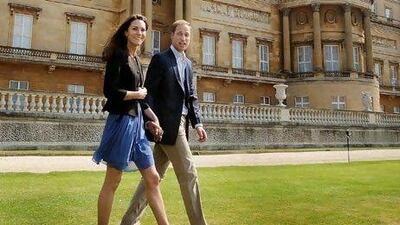 British royal newlyweds Prince William and Catherine, Duchess of Cambridge, walk hand-in-hand at Buckingham Palace in London on Saturday, after they were joined at a ceremony at Westminster Abbey the previous day. EPA