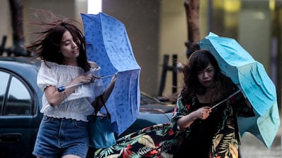People struggle with the wind as they cross the street under the rain as typhoon Mitag is expected to hit northern Taiwan, in Keelung, Taiwan. According to report, Typhoon Mitag will disrupt air, land and water traffic. Mitag is located at sea about 290 kilometers off the south-southeast of Yilan County, moving at 27 kilometers per hour at a northwesterly direction, with maximum sustained winds of 126 kilometers per hour, with gusts of up to 162 kilometers per hour, and with a radius of 180 kilometers, according to Taiwan Central Weather Bureau. EPA