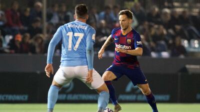 Barcelona midfielder Ivan Rakitic vies with UD Ibiza midfielder Javi Perez. AFP