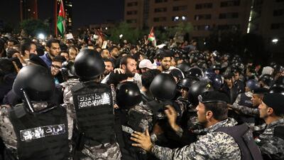 Jordanian security forces block protesters during a demonstration against the newly proposed income tax reforms and hike in petrol tax in Amman, Jordan, on June 4, 2018. Andre Pain / EPA