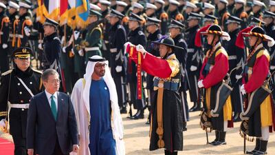 Sheikh Mohamed bin Zayed and Mr Moon inspect the honour guard during a reception at the Blue House. Rashed Al Mansoori / Ministry of Presidential Affairs