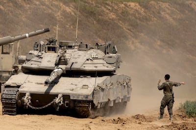 An Israeli soldier directs a tank near the border with the Gaza Strip on March 18, 2025 in southern Israel. Getty Images.