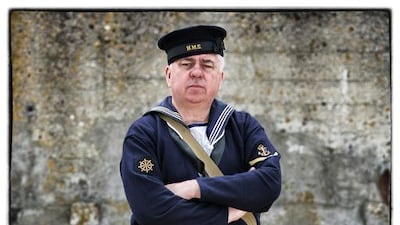 Joseph Smith, from the United Kingdom, wears a replica uniform of an British Royal Navy Rating.