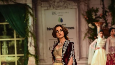 Showing her versatility, Anju Modi put Bollywood actress Kangna Ranaut in a cream lehenga with a Victorian-style velvet jacket. AFP