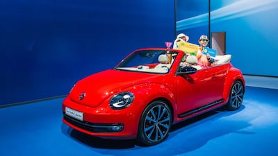 Three ‘men’ have their photograph taken in a VW Beetle Cabriolet on the opening night of the Dubai International Motor Show, which runs until Saturday, November 14. Alex Atack for The National.