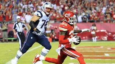 Kansas City Chiefs player Husain Abdullah, right, runs the ball in for a touchdown against the New England Patriots on Monday night in the NFL. Larry W Smith / EPA / September 29, 2014