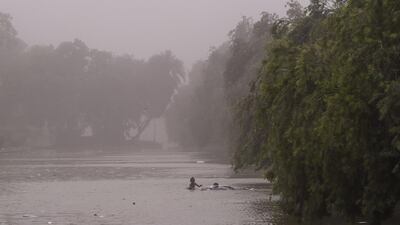 Indian children swim in a pond during a dust storm in New Delhi on May 2. Chandan Khanna / AFP Photo