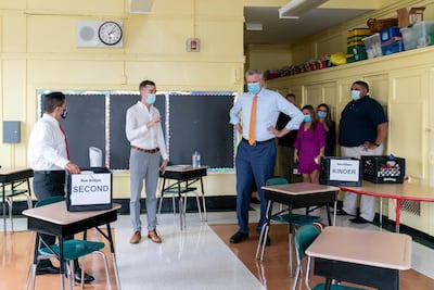 Bill de Blasio, mayor of New York, listens to Kevyn Bowles, principal of New Bridges Elementary, ahead of schools reopening, in Brooklyn, New York City, US, August 19. Jeenah Moon/Pool via Reuters